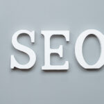 SEO (Search Engine Optimization) in white letter on gray background